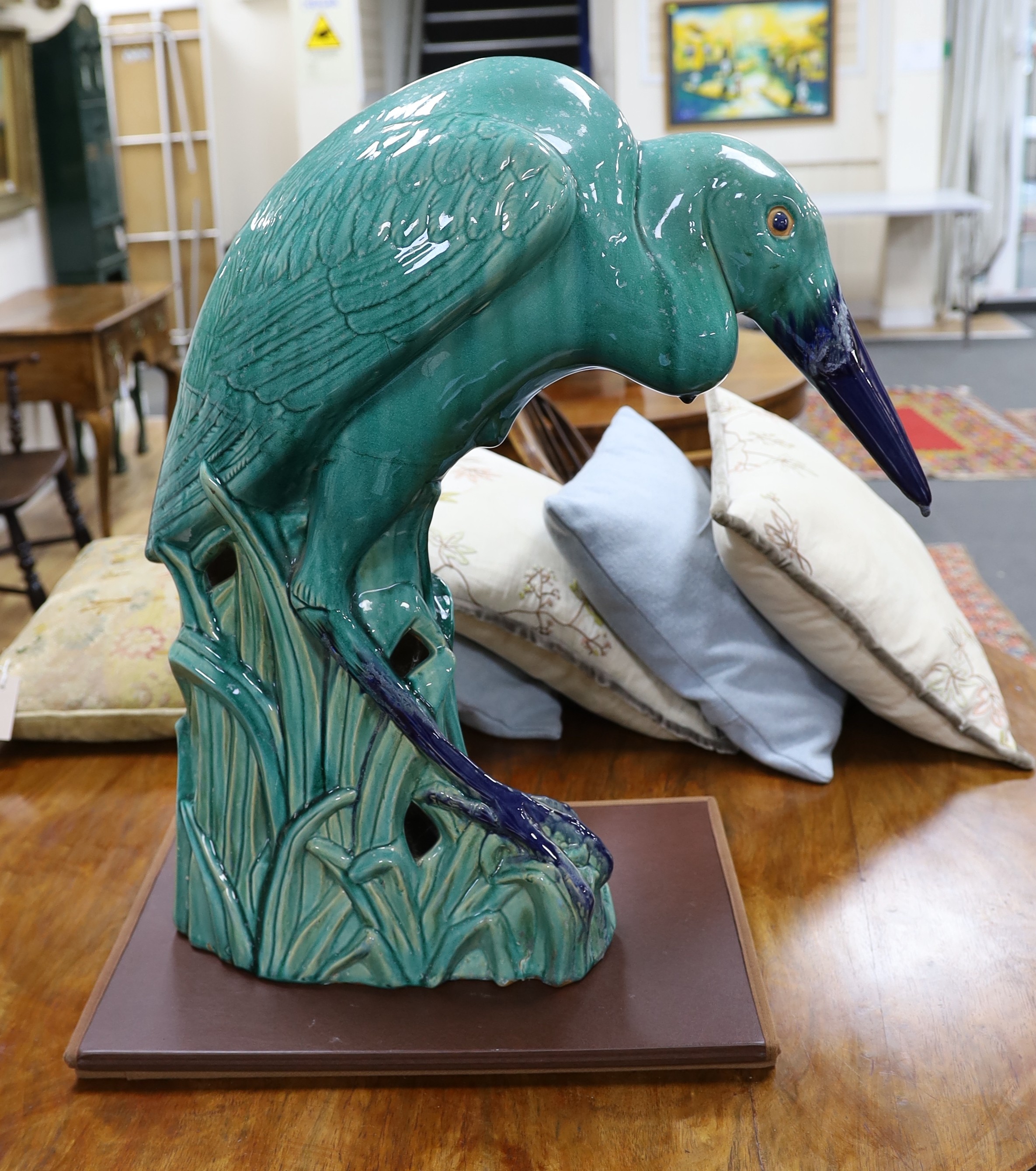 A large Chinese Shiwan style model of a heron, 66cm tall